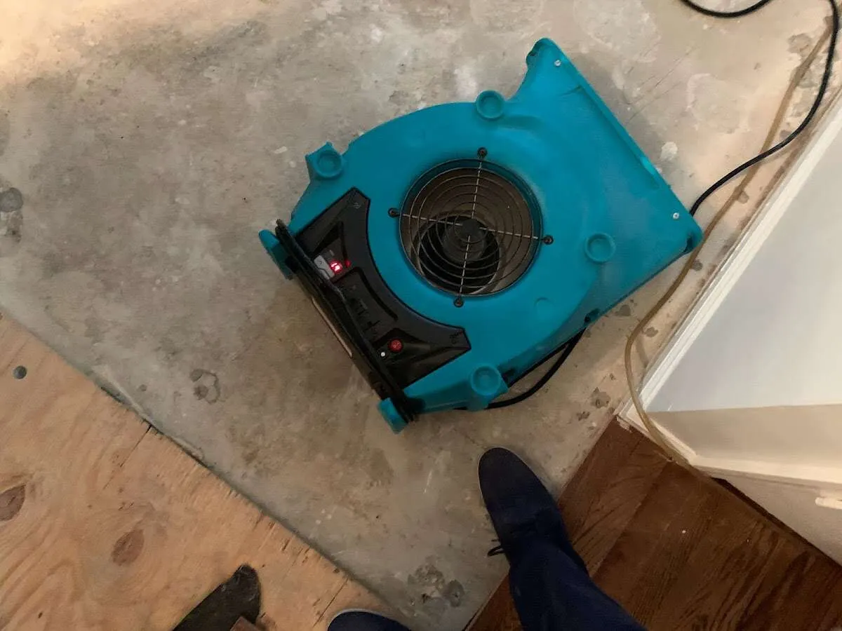 Air mover drying subfloor during Commercial Water Damage Restoration in Galt